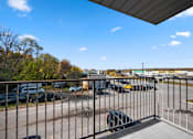 Thumbnail 37 of 53 - a balcony with a metal railing overlooking a parking lot