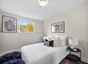 Thumbnail 17 of 53 - a bedroom with a bed and a nightstand