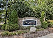 Thumbnail 3 of 35 - A sign that says Fieldstone in front of a green hedge.