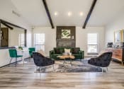 Thumbnail 26 of 46 - a living room with a green couch and chairs