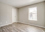 Thumbnail 38 of 46 - an empty living room with wood flooring and a window