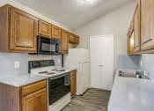 Thumbnail 30 of 46 - a kitchen with wooden cabinets and white appliances