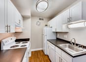 Thumbnail 23 of 31 - a kitchen with white cabinets and white appliances