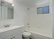 Thumbnail 12 of 31 - a bathroom with a toilet and a sink and a tub