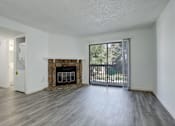 Thumbnail 5 of 31 - an empty living room with a fireplace and a sliding glass door