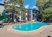Thumbnail 2 of 31 - a swimming pool with an apartment building in the background