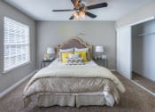 Thumbnail 16 of 20 - a bedroom with a large bed and a ceiling fan