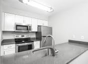 Thumbnail 6 of 17 - a kitchen with a sink stove and microwave