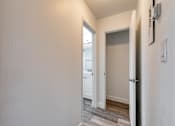 Thumbnail 10 of 24 - a bedroom with a medium sized window and a door that leads to a bathroom