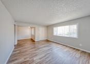 Thumbnail 9 of 17 - a bedroom with hardwood floors and a large window