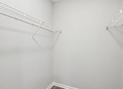 Thumbnail 20 of 35 - A white empty room with a metal rack on the wall.