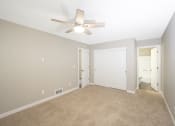 Thumbnail 8 of 17 - a bedroom with a ceiling fan and carpet