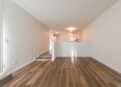 Thumbnail 22 of 25 - a bedroom with hardwood floors and white walls