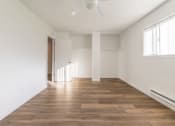 Thumbnail 18 of 25 - a bedroom with hardwood floors and white walls