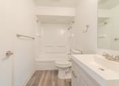 Thumbnail 17 of 25 - a bathroom with a toilet sink and bathtub