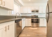 Thumbnail 23 of 25 - a kitchen with white cabinets and stainless steel appliances
