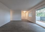 Thumbnail 19 of 41 - a bedroom with a large window and white walls