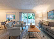 Thumbnail 10 of 41 - a living room with couches chairs and a coffee table in front of a sliding glass door