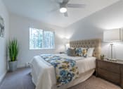 Thumbnail 12 of 41 - a bedroom with a large bed and a ceiling fan