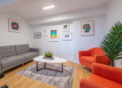 Thumbnail 22 of 41 - a living room with couches chairs and a coffee table