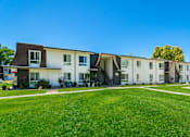 Thumbnail 17 of 36 - a row of houses with a green lawn in front of them