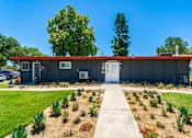 Thumbnail 4 of 36 - a building with a red roof and a white door