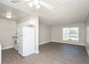 Thumbnail 15 of 36 - an empty living room with a kitchen in the background