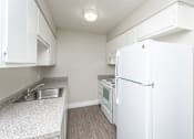Thumbnail 13 of 36 - a kitchen with white appliances and white cabinets