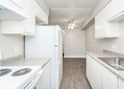 Thumbnail 14 of 36 - a kitchen with white cabinets and white appliances