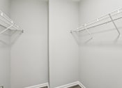 Thumbnail 18 of 35 - Two empty wire shelves in a white room.