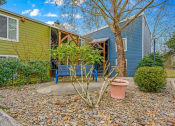 Thumbnail 36 of 42 - a backyard with a blue bench and a tree