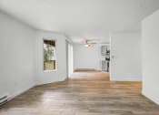 Thumbnail 33 of 42 - a renovated living room with hardwood floors and white walls