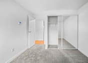 Thumbnail 31 of 42 - a bedroom with white walls and carpet