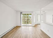Thumbnail 26 of 42 - a bedroom with hardwood floors and white walls