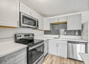 Thumbnail 28 of 42 - a kitchen with white cabinets and stainless steel appliances