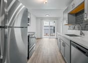 Thumbnail 39 of 42 - a kitchen with gray cabinets and stainless steel appliances