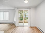 Thumbnail 17 of 42 - a living room with hardwood floors and white walls