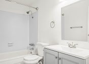 Thumbnail 13 of 42 - a bathroom with a sink toilet and bathtub