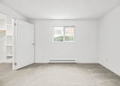 Thumbnail 12 of 42 - a bedroom with a large window and white walls