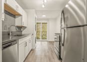 Thumbnail 10 of 42 - a kitchen with white cabinets and stainless steel appliances