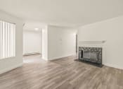 Thumbnail 8 of 42 - a living room with a fireplace and hardwood floors