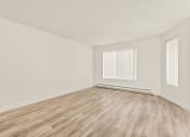 Thumbnail 7 of 42 - a bedroom with hardwood floors and white walls