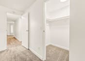 Thumbnail 4 of 42 - a bedroom with white walls and a carpeted floor