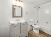 Thumbnail 40 of 42 - a bathroom with a white sink and toilet next to a white bathtub