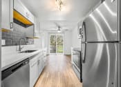 Thumbnail 35 of 42 - a kitchen with white cabinets and stainless steel appliances
