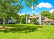 Thumbnail 2 of 17 - a large grassy area with houses in the background