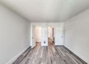 Thumbnail 17 of 24 - a bedroom with hardwood floors and white walls