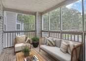 Thumbnail 4 of 20 - a screened in porch with a couch and chairs