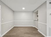 Thumbnail 97 of 98 - A room with wooden flooring and white walls.