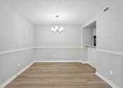 Thumbnail 91 of 98 - A room with wooden floors and white walls.